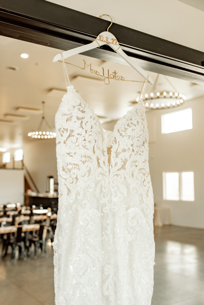 wedding dress hanging with white bridal hanger 